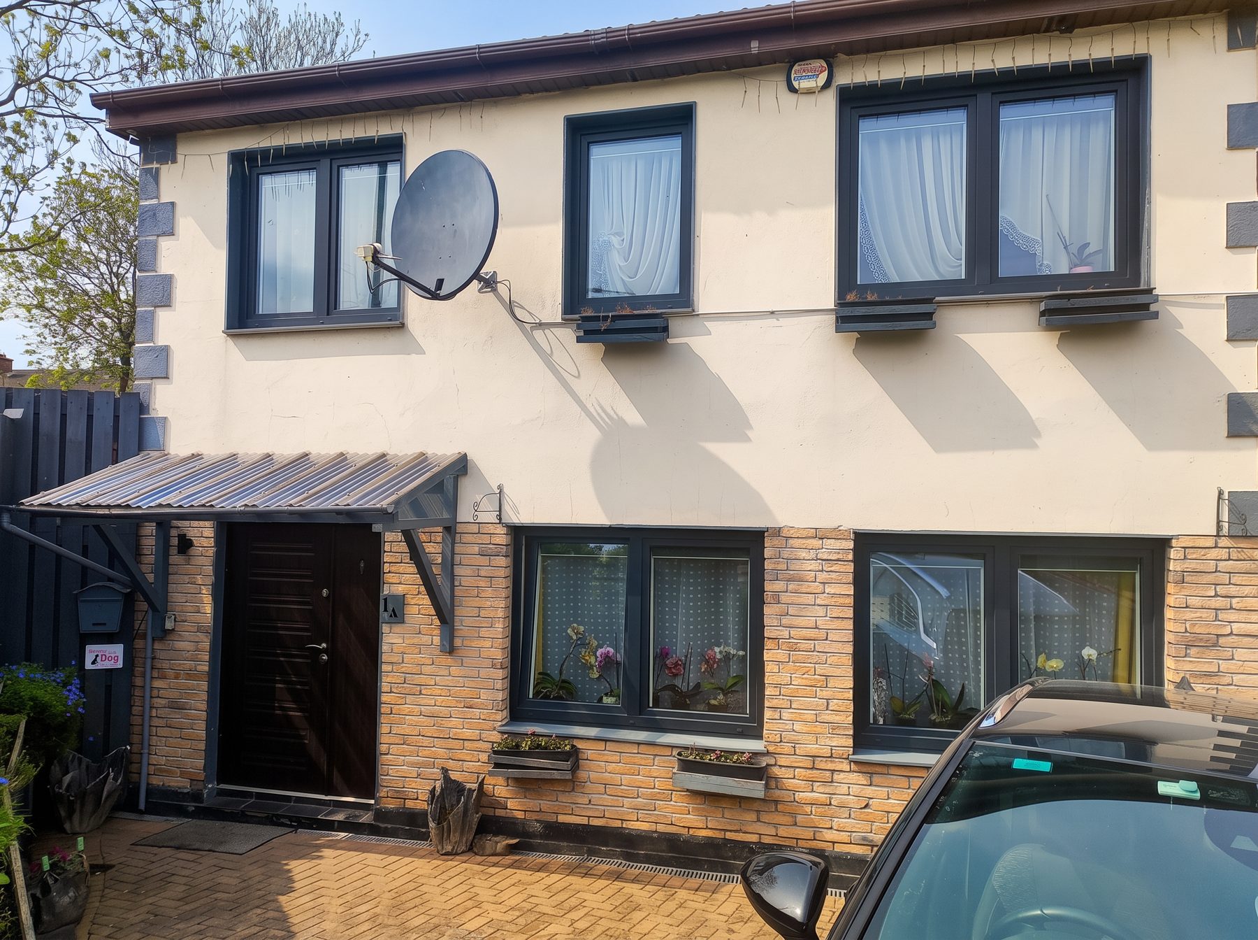 Terraced house with render and brick lower frontage