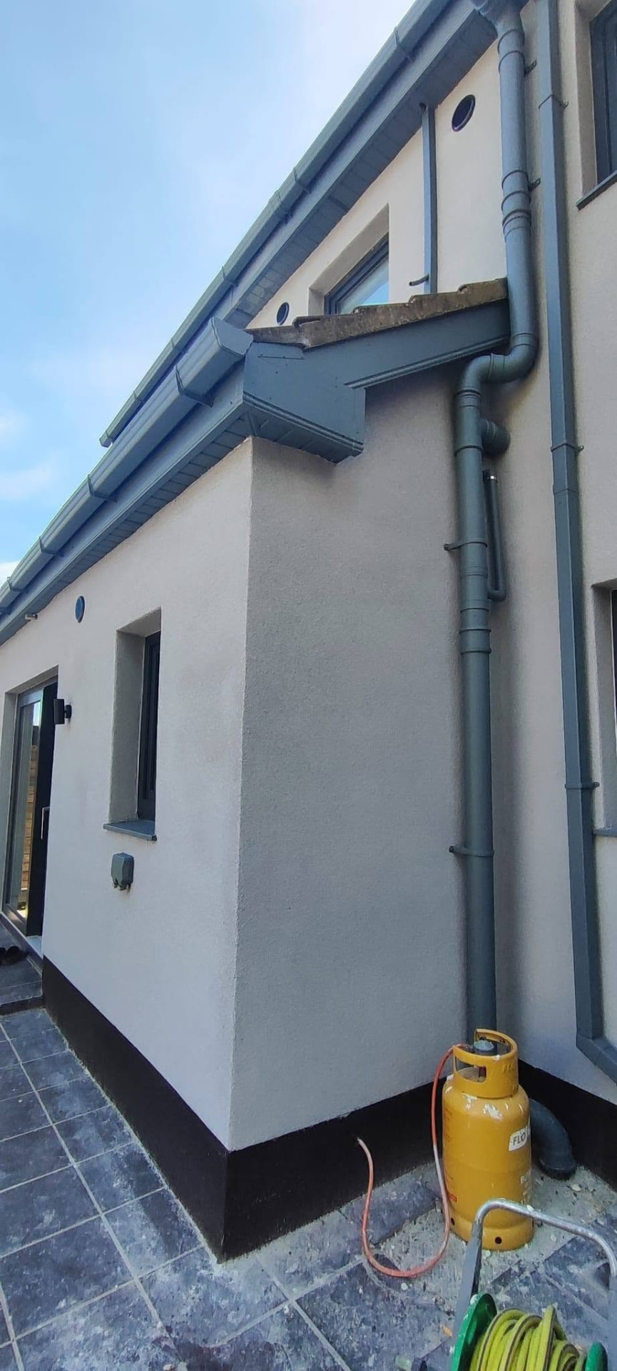 Render corner detail with downpipes